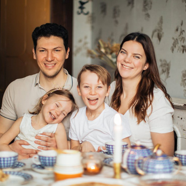 Parent and teenager reviewing consent documents together at home, warm family moment, professional lifestyle photography, natural lighting